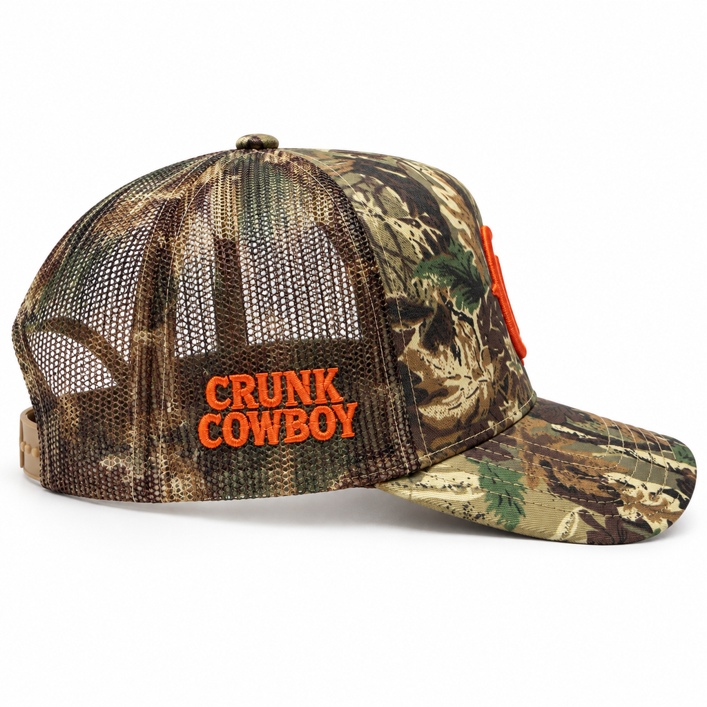Crunk Cowboy green camo trucker cap with orange logos, embroidered side view